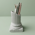Personalized Greek column pencil holder engraved with a teacher's name and filled with pencils and pens, displayed as an elegant desk organizer for classrooms and offices.